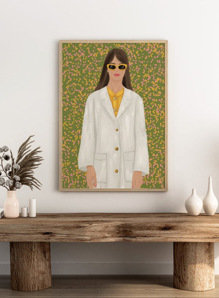 A stylized portrait of a woman wearing a white coat over a yellow top and yellow sunglasses, set against a green background filled with small pink and yellow dots. Chic Woman in Sunglasses by Lisa Solomoniuk premium framed fine art print featuring a woman in an oversized white coat and yellow sunglasses.