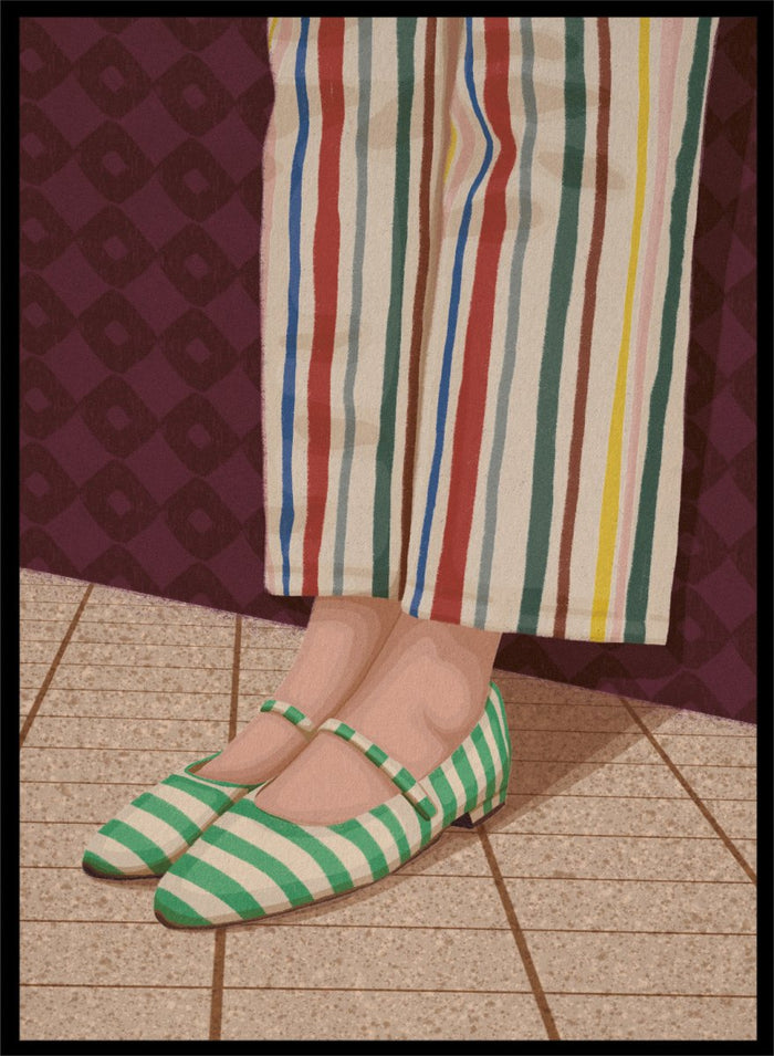 A close-up of a person's feet wearing green and white striped Mary Jane flats, paired with cream-colored striped trousers, standing on a tiled floor against a dark patterned wall. Colorful Striped Mary Janes by Lisa Solomoniuk premium framed fine art print featuring green striped shoes and colorful wide-leg trousers.