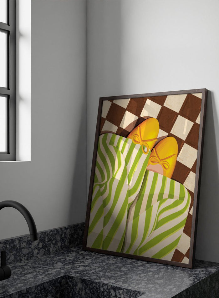 A stylized illustration of a person wearing green and white striped pajama pants and yellow slip-on shoes with bow details, lying on a brown and cream checkered floor. Cozy Striped Feet by Lisa Solomoniuk premium framed fine art print featuring yellow slippers, green striped trousers, and a bold checkered floor.