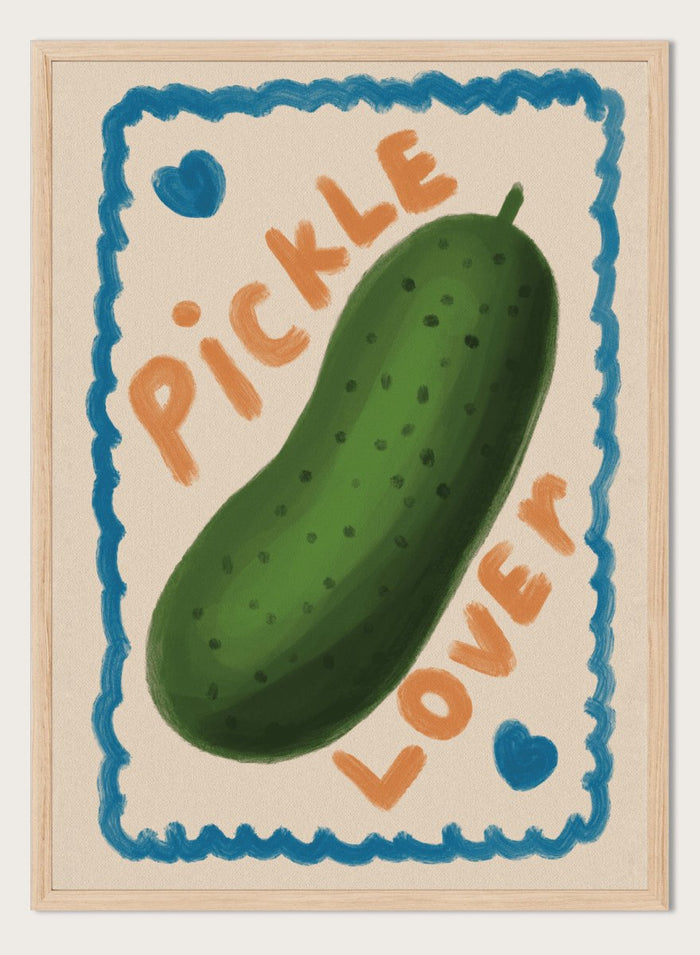 An art print featuring a hand-drawn green pickle centered on a cream background, surrounded by a blue scalloped border. The words 'PICKLE' and 'LOVER' appear in orange lettering, with two small blue hearts near the corners. Cute Pickle Lover by Lisa Solomoniuk premium framed fine art print featuring a giant green pickle, playful lettering, blue hearts, and a hand-painted border.
