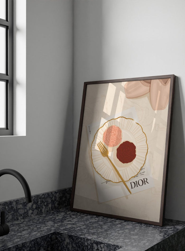 A stylized flat-lay illustration featuring a white plate with a gold rim holding two rose-shaped pastries, one light pink and one dark chocolate brown, with a gold fork on top. Elegant Cupcakes Ballet Shoes by Lisa Solomoniuk premium framed fine art print featuring pink ballet shoes, frosted cupcakes, and gold details.