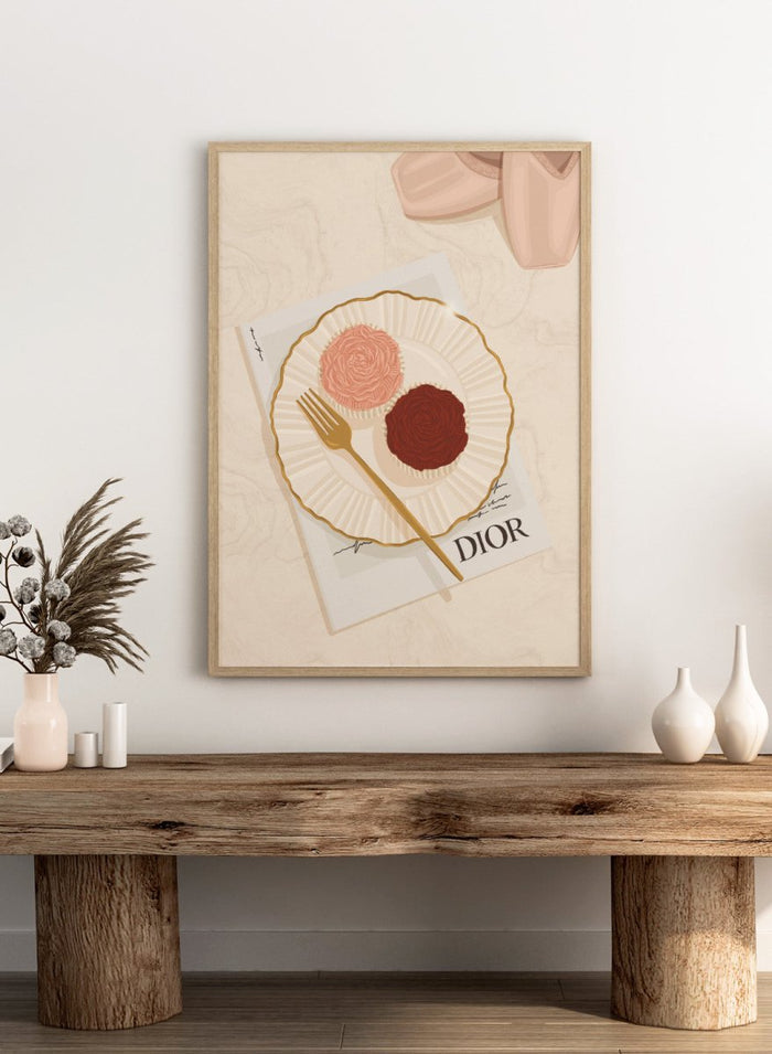 A stylized flat-lay illustration featuring a white plate with a gold rim holding two rose-shaped pastries, one light pink and one dark chocolate brown, with a gold fork on top. Elegant Cupcakes Ballet Shoes by Lisa Solomoniuk premium framed fine art print featuring pink ballet shoes, frosted cupcakes, and gold details.