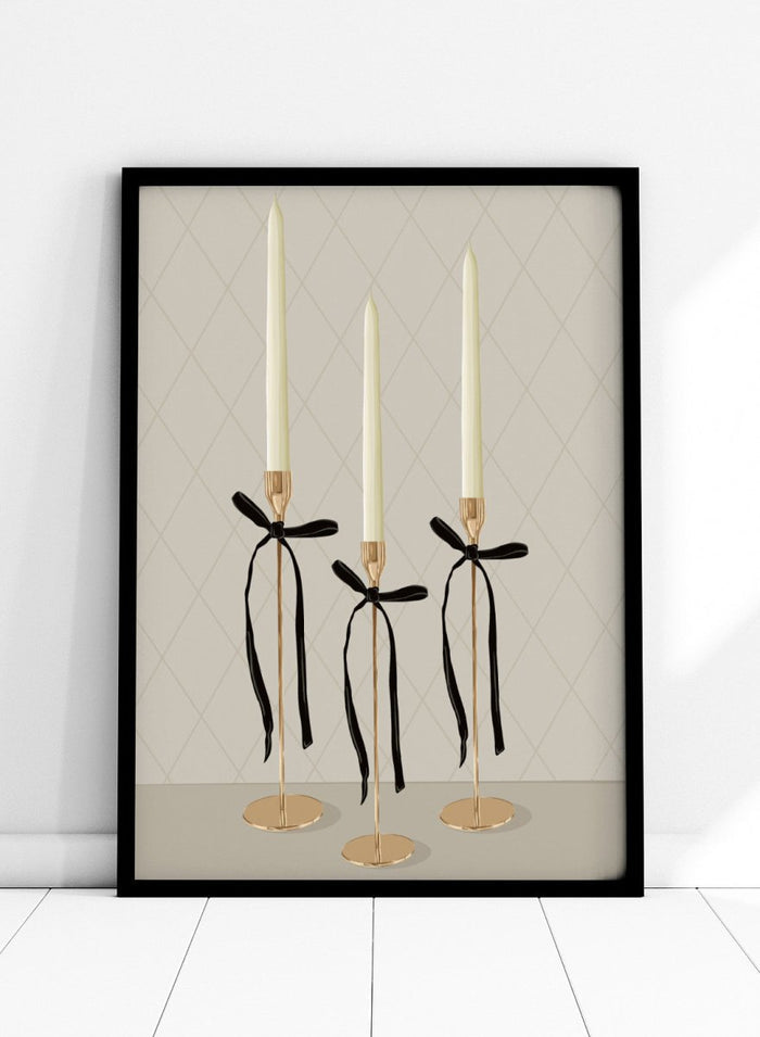 Three gold taper candle holders with cream candles and black ribbon bows, arranged on a light gray surface against a beige diamond-patterned background. Elegant Gold Taper Candles by Lisa Solomoniuk premium framed fine art print featuring gold candlesticks, cream tapers, and long black ribbons.