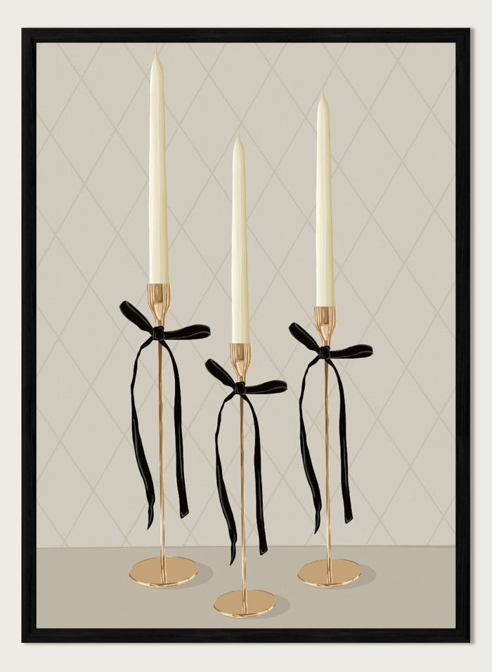 Three gold taper candle holders with cream candles and black ribbon bows, arranged on a light gray surface against a beige diamond-patterned background. Elegant Gold Taper Candles by Lisa Solomoniuk premium framed fine art print featuring gold candlesticks, cream tapers, and long black ribbons.
