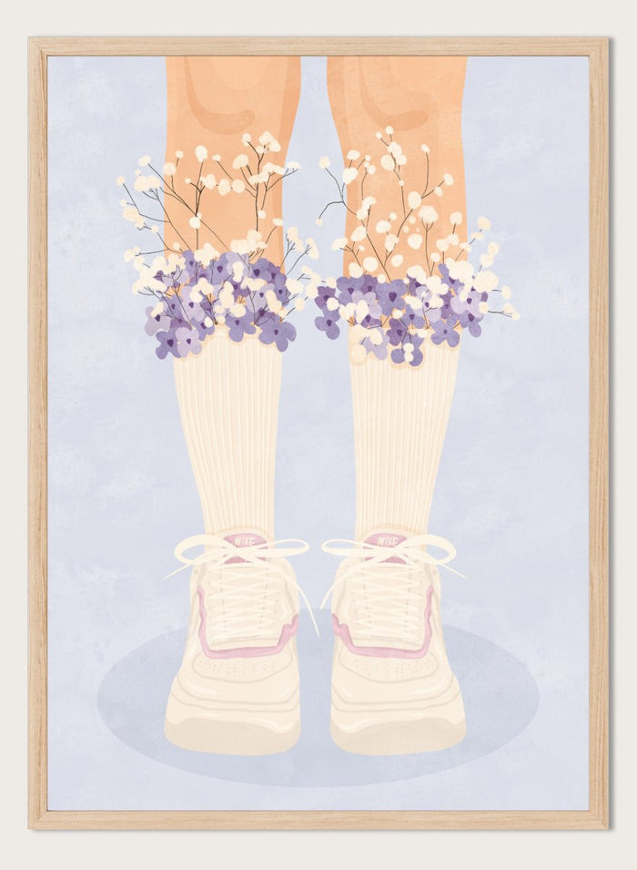 A stylized illustration of a person's legs wearing cream ribbed socks, white sneakers with pink trim, and bunches of small white and purple flowers at the top of the socks, set against a pale blue background. Floral Socks and Sneakers by Lisa Solomoniuk premium framed fine art print featuring cream sneakers with purple and white flowers.