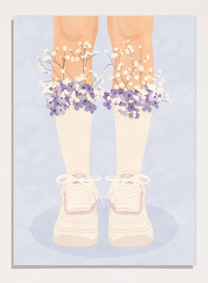 A stylized illustration of a person's legs wearing cream ribbed socks, white sneakers with pink trim, and bunches of small white and purple flowers at the top of the socks, set against a pale blue background. Floral Socks and Sneakers by Lisa Solomoniuk premium framed fine art print featuring cream sneakers with purple and white flowers.