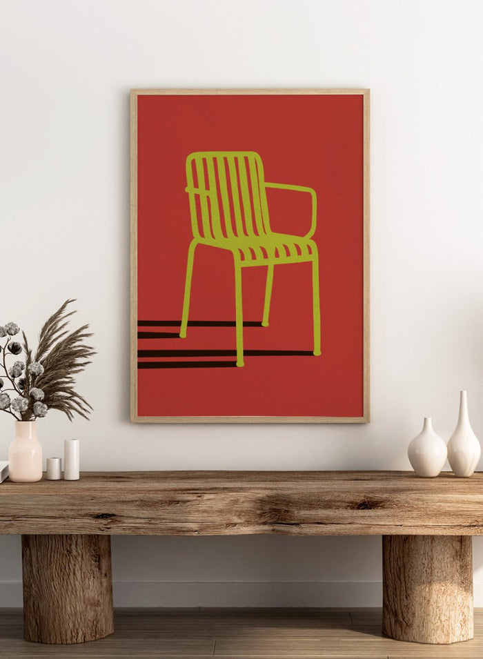 A minimalist graphic art print of a modern armchair, featuring a lime green chair silhouette on a solid red background with bold black shadows. Green Chair Shadow by Lisa Solomoniuk premium framed fine art print featuring a bright green chair and long black shadow against a deep red background.