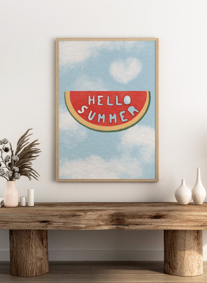An art print featuring a watermelon slice graphic with the words 'HELLO SUMMER' in white letters, set against a light blue sky with white clouds background. Hello Summer Watermelon by Lisa Solomoniuk fine art print featuring a playful watermelon slice, soft clouds, and bright summer color.