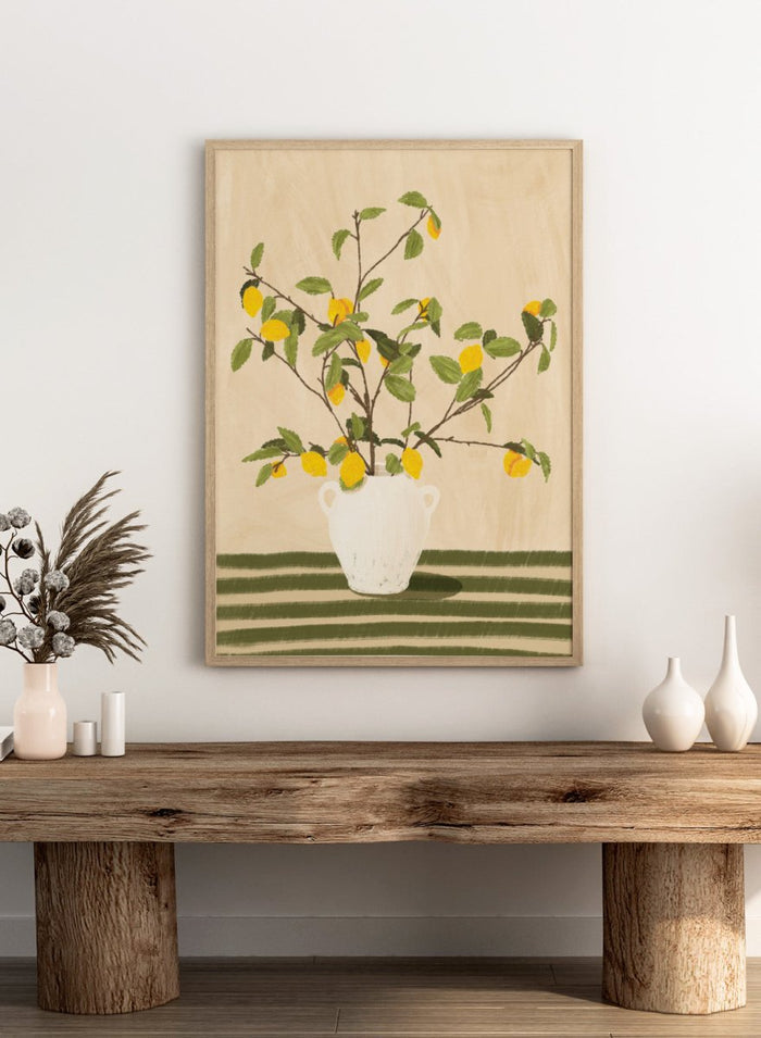A framed still life artwork showing yellow lemons on leafy branches arranged in a white vase, set against a warm beige background with green horizontal stripes at the bottom. Lemon Tree Still Life by Lisa Solomoniuk premium framed fine art print featuring bright yellow lemons in a white vase on a striped green table.