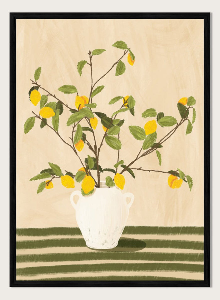 A framed still life artwork showing yellow lemons on leafy branches arranged in a white vase, set against a warm beige background with green horizontal stripes at the bottom. Lemon Tree Still Life by Lisa Solomoniuk premium framed fine art print featuring bright yellow lemons in a white vase on a striped green table.
