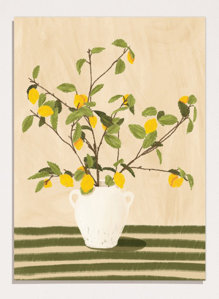 A framed still life artwork showing yellow lemons on leafy branches arranged in a white vase, set against a warm beige background with green horizontal stripes at the bottom. Lemon Tree Still Life by Lisa Solomoniuk premium framed fine art print featuring bright yellow lemons in a white vase on a striped green table.