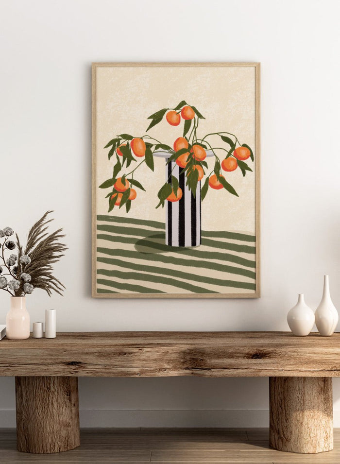 A stylized still life illustration of orange branches with green leaves and ripe oranges arranged in a black-and-white striped vase on a striped surface against a warm cream background. Orange Branches Vase by Lisa Solomoniuk premium framed fine art print featuring bright orange fruit, green leaves, and a striped black-and-white vase.