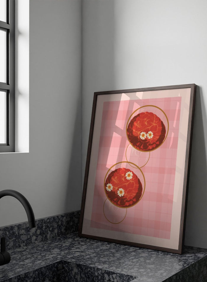 A stylized art print featuring two overlapping pink and red plaid glasses with white daisy flowers, framed by a black border on a light pink background. Pink Drinks With Daisies by Lisa Solomoniuk premium framed fine art print featuring red coupe glasses, floating daisies, and pink gingham.