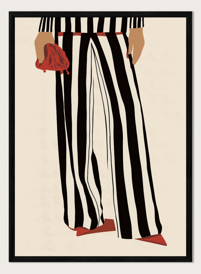 Fashion illustration of a person from the waist down wearing black and white vertically striped wide-leg trousers, with a red belt, red pointed shoes, and holding a red clutch against a cream background. Red Heels and Stripes by Lisa Solomoniuk premium framed fine art print featuring bold black-and-white stripes, pointed red heels, and a matching bag.
