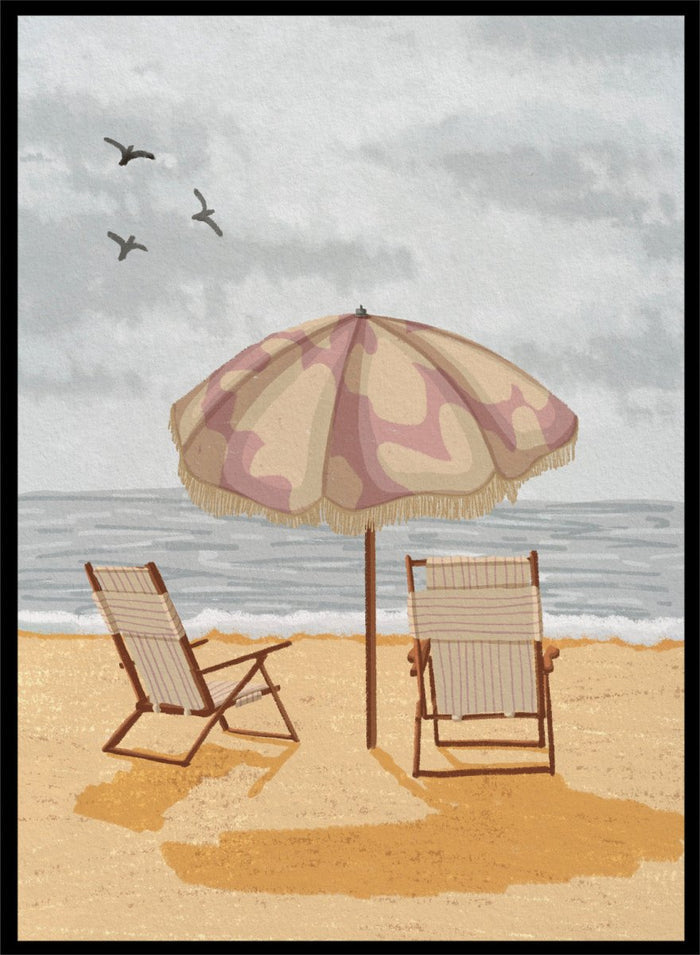 A beach scene artwork showing two wooden deck chairs under a beige and dusty pink patterned umbrella on a sandy shore, with the ocean and cloudy sky behind them. Two birds are visible in the sky. Seaside Umbrella Chairs by Lisa Solomoniuk premium framed fine art print featuring striped beach chairs beneath a fringed umbrella by the sea.