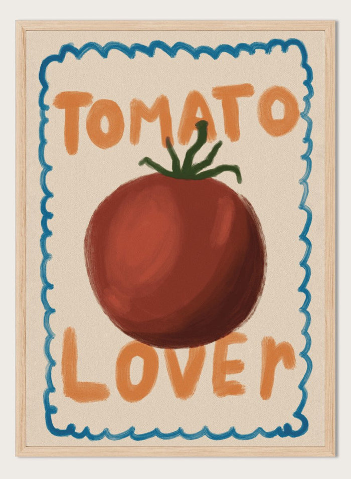 An art print featuring a painted red tomato with a green stem, surrounded by a scalloped blue border on a cream background. The words 'TOMATO' at the top and 'LOVER' at the bottom are written in orange hand-drawn lettering. Tomato Lover by Lisa Solomoniuk premium framed fine art print featuring an oversized tomato, playful hand-painted lettering, and a wavy border.