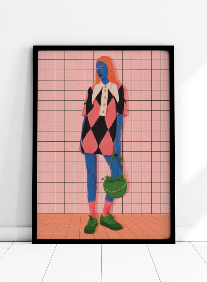 A stylized fashion illustration of a person with blue skin and orange hair, wearing a pink and black harlequin dress with a white collar, blue leggings, green shoes, and carrying a green bag, set against a pink grid background. Vibrant Argyle Style by Lisa Solomoniuk premium framed fine art print featuring a bold fashion figure in bright pink, blue, green, and black.