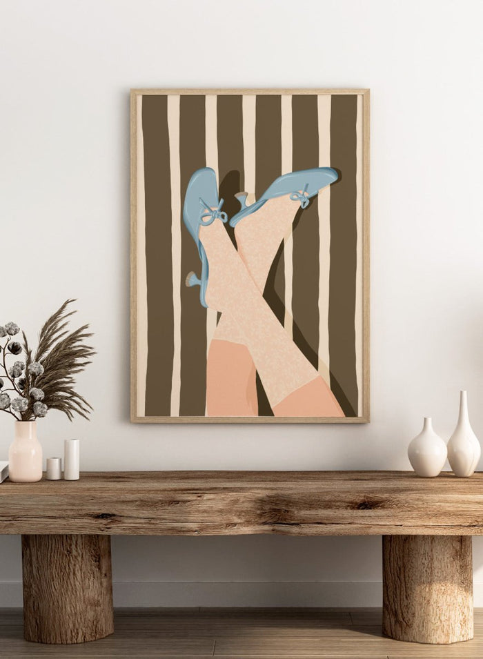 A stylized illustration of crossed legs wearing beige patterned socks and light blue kitten-heel flats with bow details, set against a brown and cream striped background. Whimsical Blue Heels by Lisa Solomoniuk premium framed fine art print featuring pale blue heels, patterned tights, and bold brown stripes.