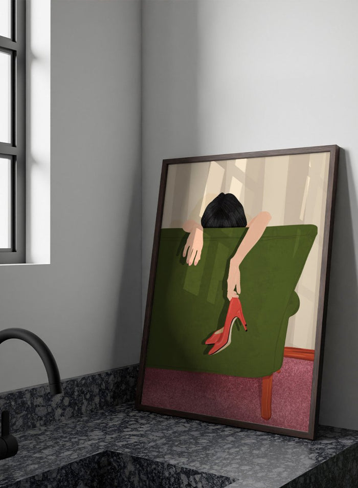 A stylized illustration of a person sitting on a green sofa, holding a pair of red high-heeled shoes. The person has dark hair and pale skin, with striped beige walls and a pink carpet in the background. Woman Resting Red Heels by Lisa Solomoniuk premium framed fine art print featuring a woman draped over a green chair holding bright red heels.