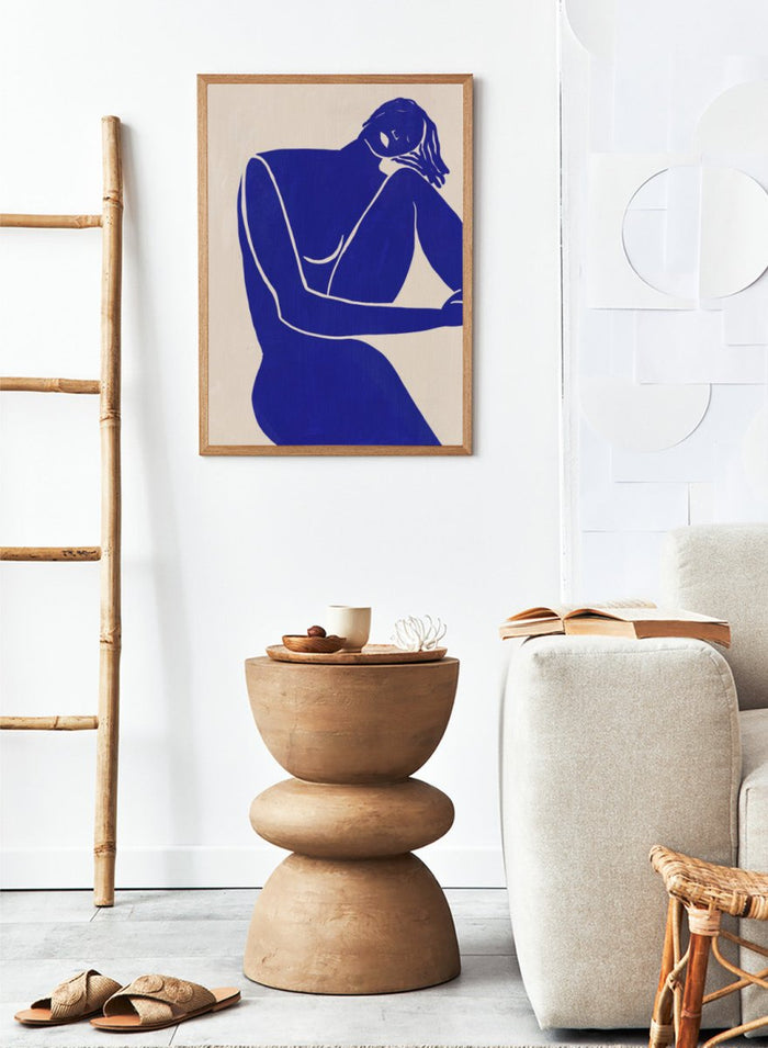 Blue line art of a woman figure on a beige background. Minimalist Blue Silhouette Figure by Little Dean modern abstract figure art print featuring bold blue female silhouette, contemporary minimalist wall art poster.