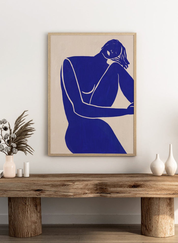 Blue line art of a woman figure on a beige background. Minimalist Blue Silhouette Figure by Little Dean modern abstract figure art print featuring bold blue female silhouette, contemporary minimalist wall art poster.