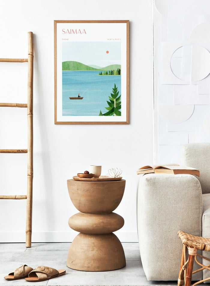 Illustration of a lake scene with a person fishing, surrounded by greenery and mountains, with 'Saimaa, Finland' text at the top. Calm Saimaa Lake Fishing by Longwayhome is a minimalist Scandinavian landscape art print featuring peaceful Finland lake scenery, forest views, and modern Nordic design.