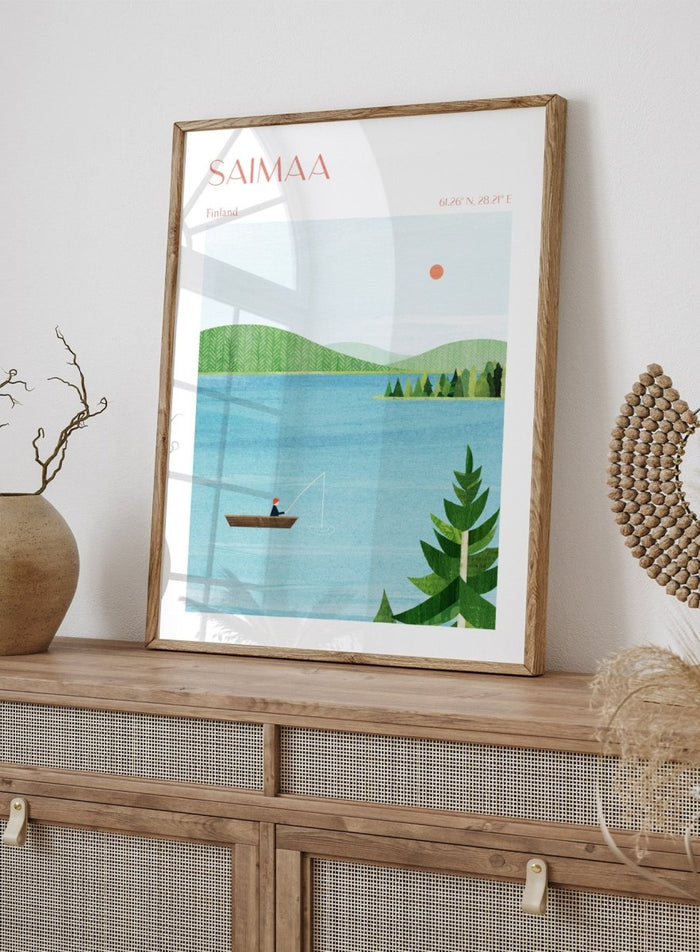 Illustration of a lake scene with a person fishing, surrounded by greenery and mountains, with 'Saimaa, Finland' text at the top. Calm Saimaa Lake Fishing by Longwayhome is a minimalist Scandinavian landscape art print featuring peaceful Finland lake scenery, forest views, and modern Nordic design.
