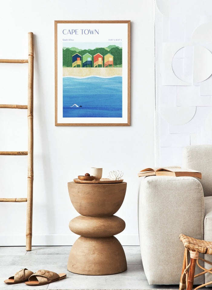 Illustration of beach huts by the sea with 'Cape Town, South Africa' text. Cape Town Beach Huts by Longwayhome is a minimalist coastal art print featuring colorful beach cabins, ocean scenery, and modern travel inspired design.