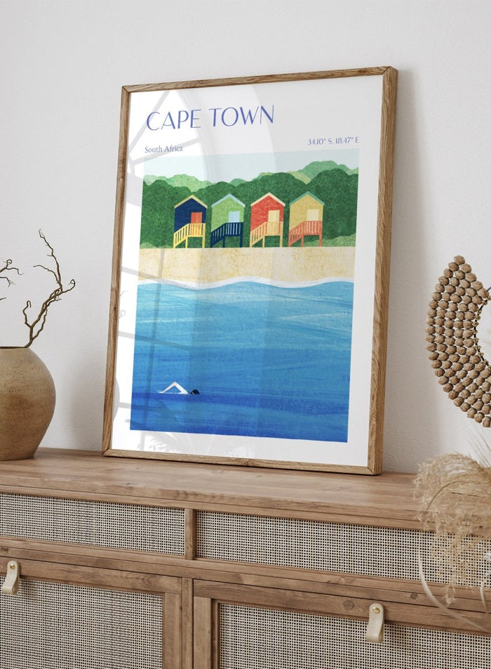 Illustration of beach huts by the sea with 'Cape Town, South Africa' text. Cape Town Beach Huts by Longwayhome is a minimalist coastal art print featuring colorful beach cabins, ocean scenery, and modern travel inspired design.