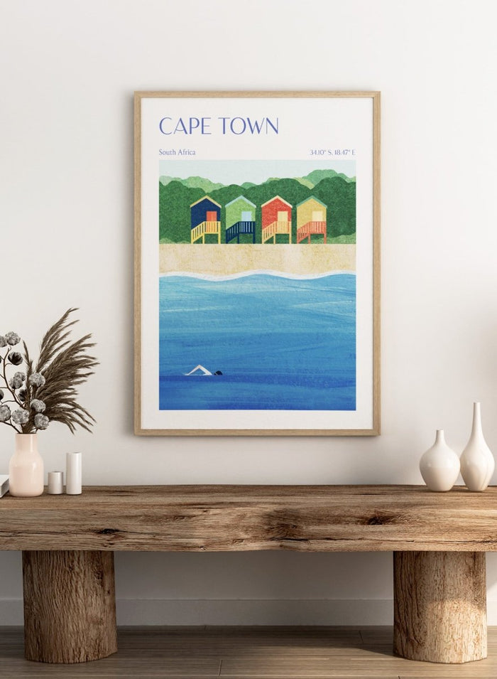 Illustration of beach huts by the sea with 'Cape Town, South Africa' text. Cape Town Beach Huts by Longwayhome is a minimalist coastal art print featuring colorful beach cabins, ocean scenery, and modern travel inspired design.