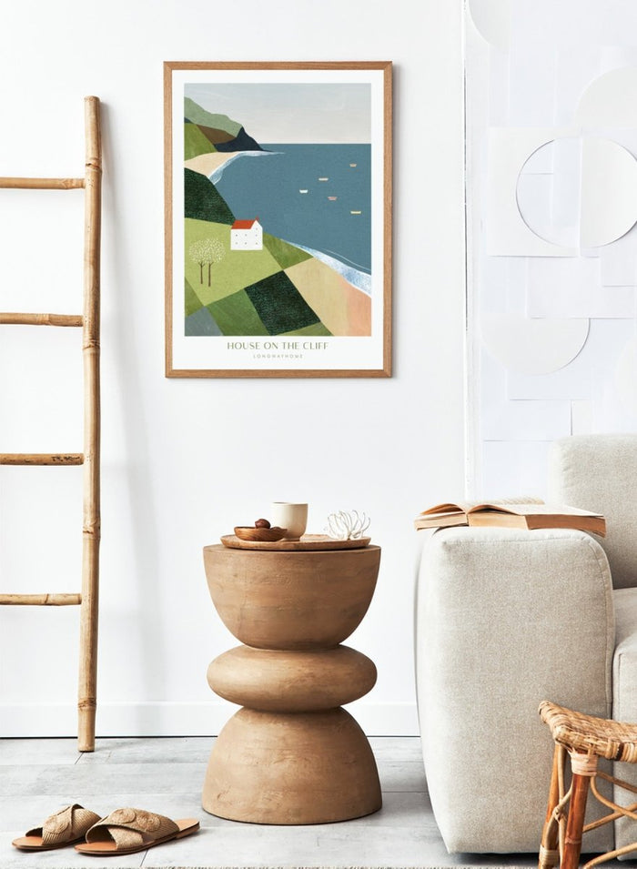 Illustration of a house on a cliff overlooking a coastal scene with boats. House on the Cliff by Longwayhome is a minimalist coastal landscape art print featuring ocean views, cliffside scenery, and modern travel inspired wall art.