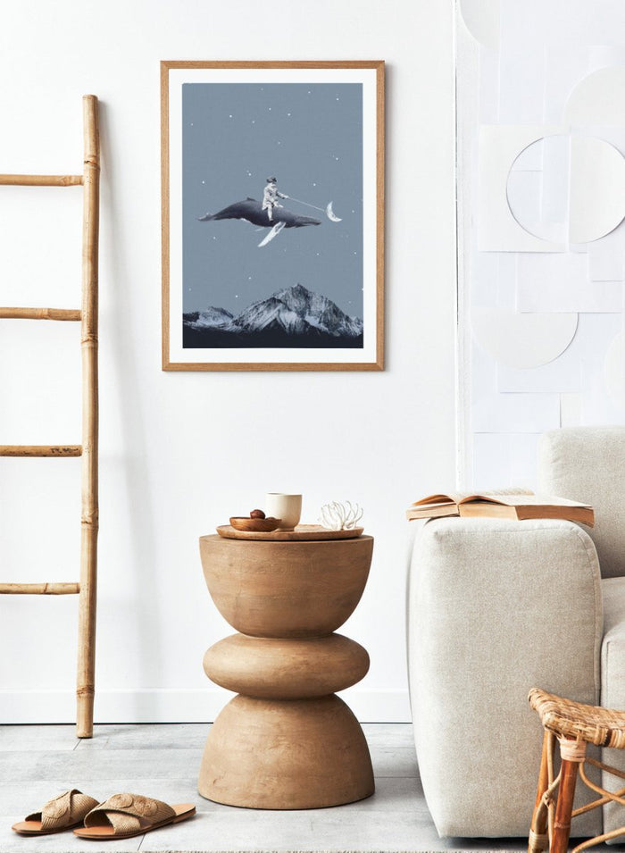Aim for the Moon by Maarten Léon is a surreal collage art print featuring a boy riding a whale in a starry sky with mountains and moon imagery.