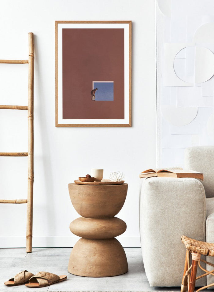 Curiosity by Maarten Léon is a minimalist collage art print showing a figure peering into a blue opening, exploring themes of curiosity and quiet discovery.