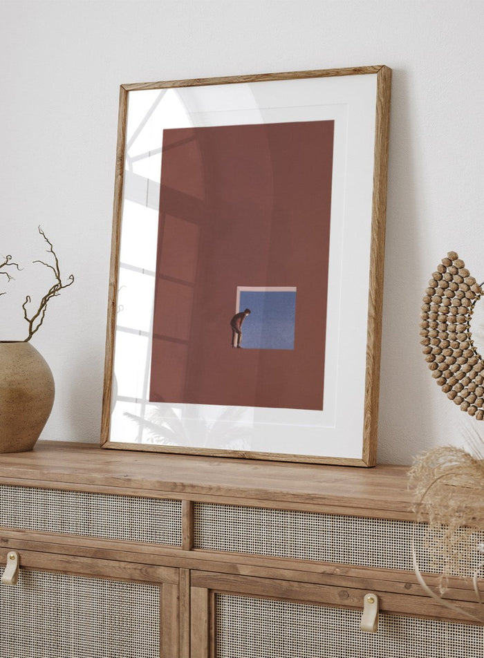 Curiosity by Maarten Léon is a minimalist collage art print showing a figure peering into a blue opening, exploring themes of curiosity and quiet discovery.