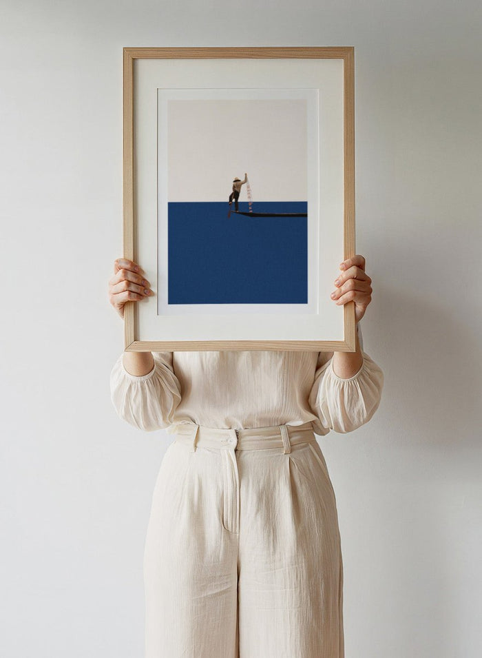 Fishing for Compliments by Maarten Léon is a minimalist collage art print featuring a fisherman at sea. Premium fine art print with real wood frame options.