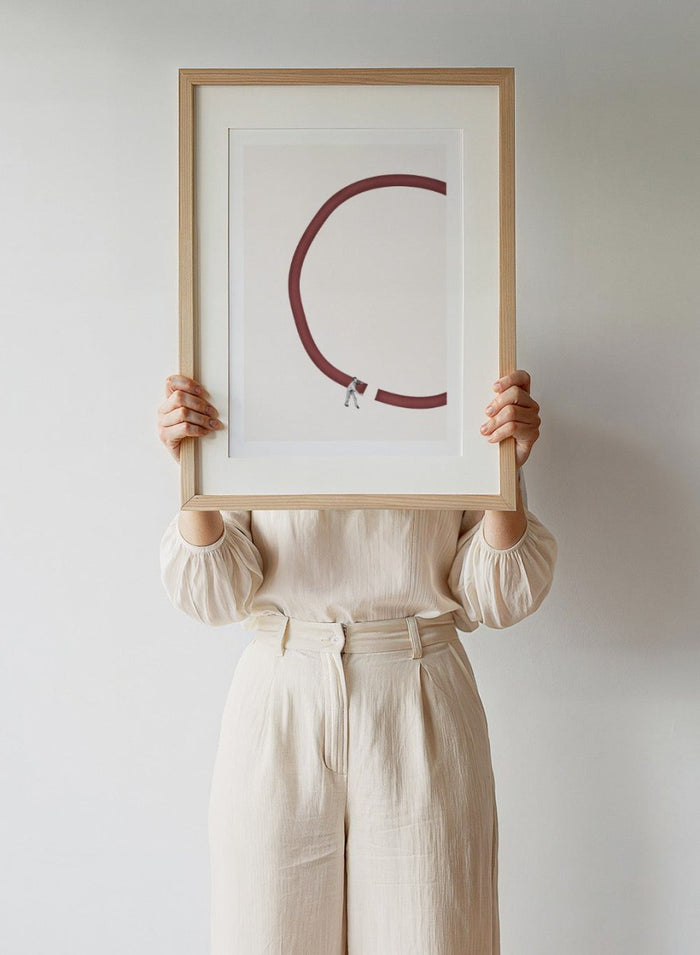 Let’s Reconnect by Maarten Léon is a minimalist collage art print showing a man repairing a broken graphic circle. Premium fine art print with real wood framing.