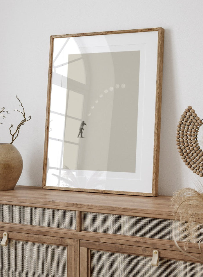 Man throwing the moon across the sky in Lucky Shot by Maarten Léon. Surreal collage wall art, minimalist contemporary poster, premium fine art with real wood frame.