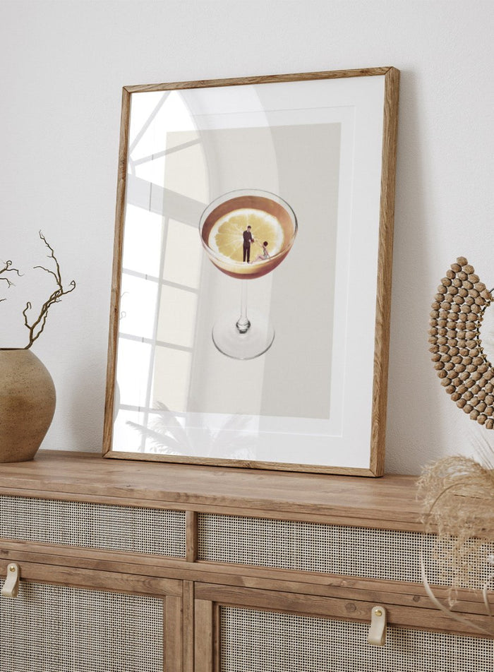 My Drink Needs a Drink by Maarten Léon is a minimalist collage art print featuring a lemon cocktail scene with vintage figures and playful surreal detail.
