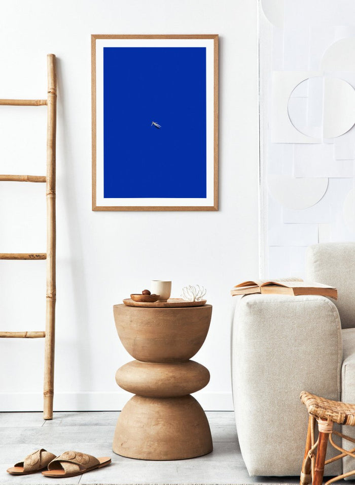 No Stress by Maarten Léon is a minimalist collage art print featuring a floating figure in a bold blue space. Premium fine art print with real wood framing.
