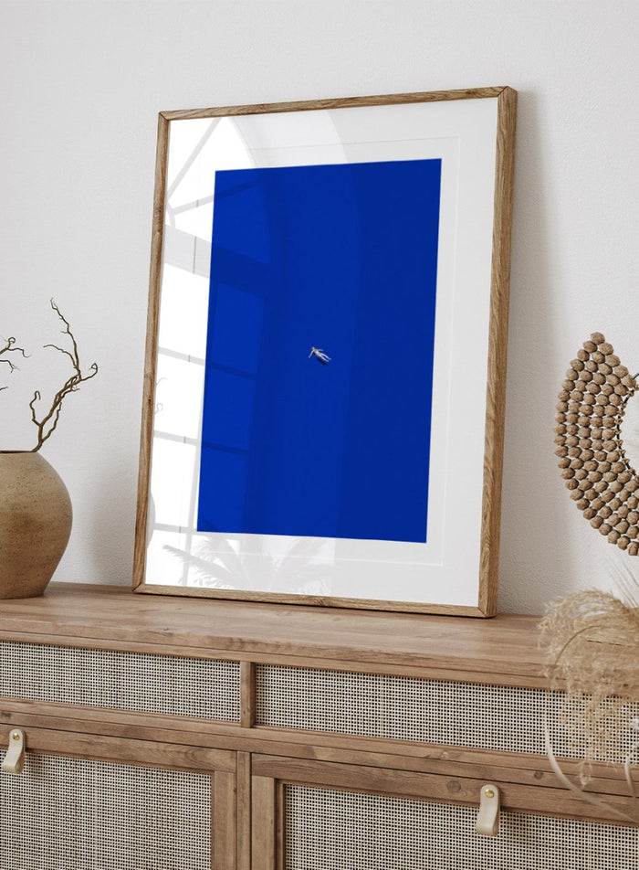 No Stress by Maarten Léon is a minimalist collage art print featuring a floating figure in a bold blue space. Premium fine art print with real wood framing.