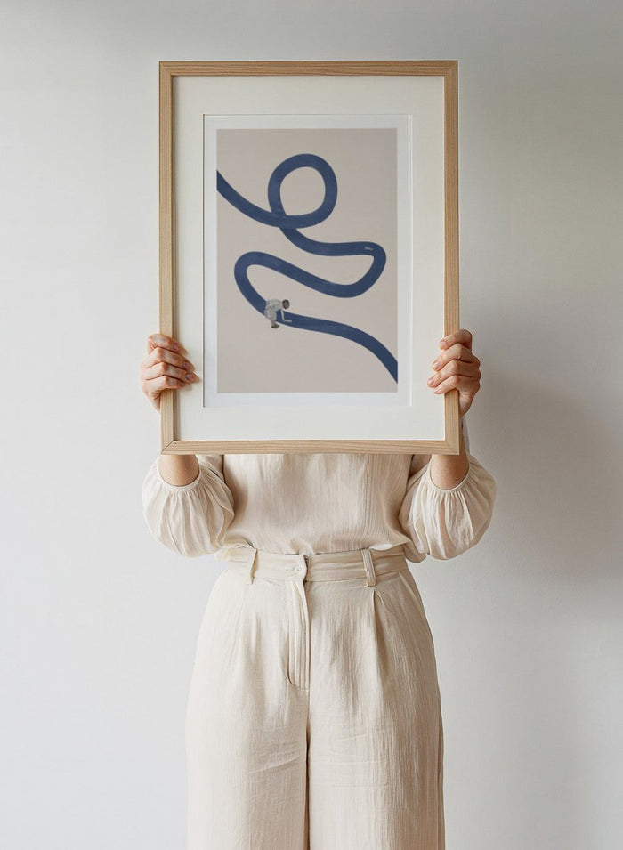 River Cleanse by Maarten Léon collage art print featuring a winding blue river and small figure cleansing the water. Premium fine art print with real wood framing.