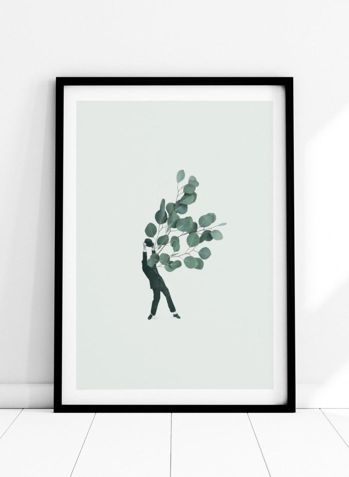 The Extravert by Maarten Léon collage art print showing a figure holding oversized eucalyptus branches. Premium fine art print with real wood framing.