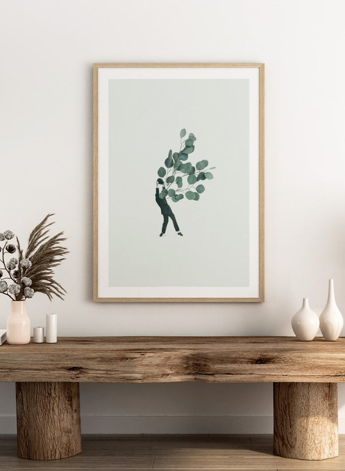 The Extravert by Maarten Léon collage art print showing a figure holding oversized eucalyptus branches. Premium fine art print with real wood framing.