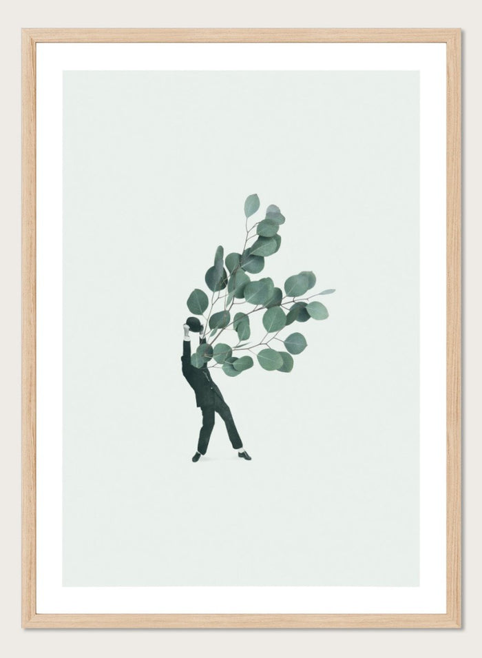 The Extravert by Maarten Léon collage art print showing a figure holding oversized eucalyptus branches. Premium fine art print with real wood framing.