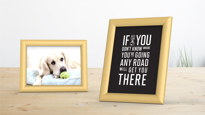 Gold picture and poster frames showcasing a dog photo and a motivational quote in stylish decor.