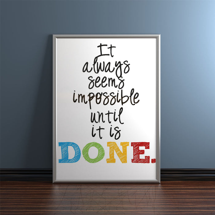 Inspirational quote in a silver picture and poster frame on a wall.