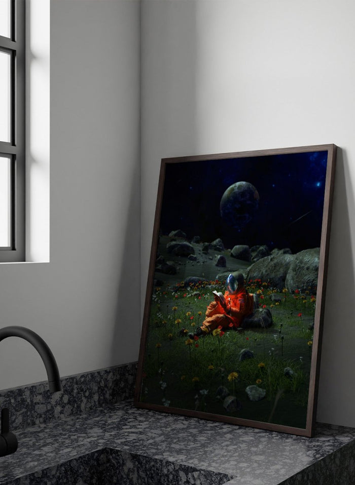 Person in orange spacesuit sitting on the moon reading a book with a large moon and stars in the background. Astronaut’s Alien Garden by Nicebleed is a surreal space art print featuring an astronaut reading in a floral alien landscape, modern aesthetic wall poster.