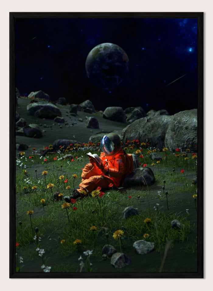 Person in orange spacesuit sitting on the moon reading a book with a large moon and stars in the background. Astronaut’s Alien Garden by Nicebleed is a surreal space art print featuring an astronaut reading in a floral alien landscape, modern aesthetic wall poster.