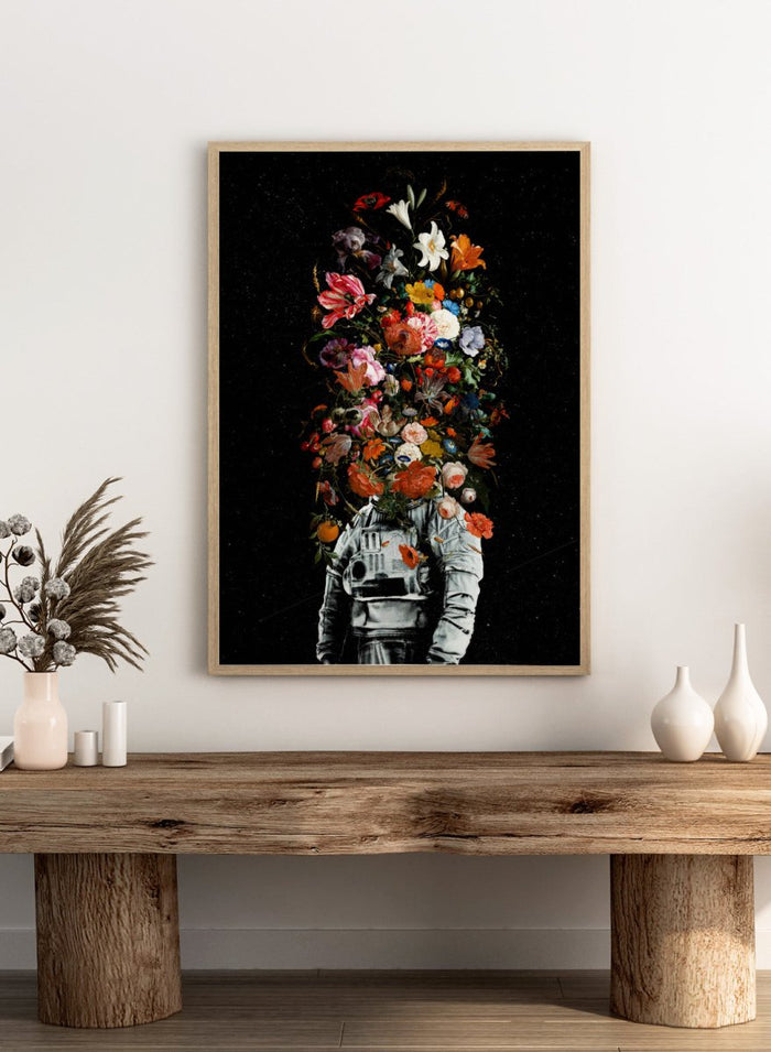 Artistic depiction of a person in astronaut suit with floral elements on a black background. Blooming Astronaut by Nicebleed is a surreal floral space art print featuring an astronaut with a head of flowers, modern aesthetic wall poster.
