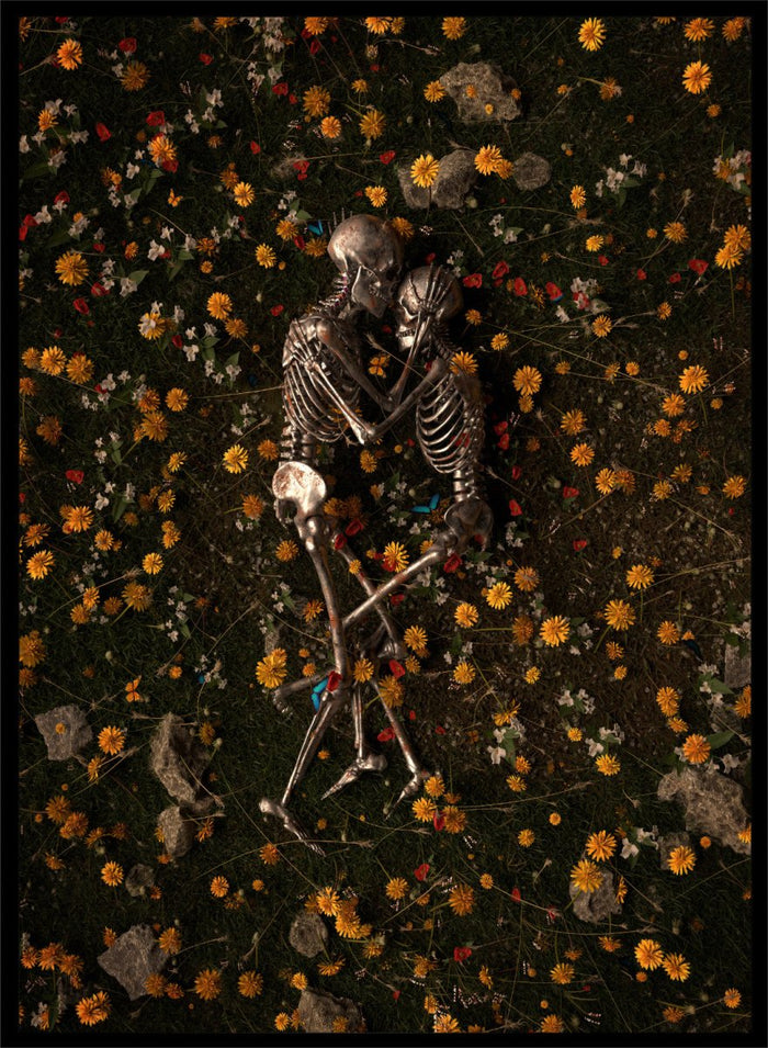 Skeletons In Love by Nicebleed is a surreal skeleton couple art print featuring intertwined skeletons in a floral field, modern aesthetic wall poster.